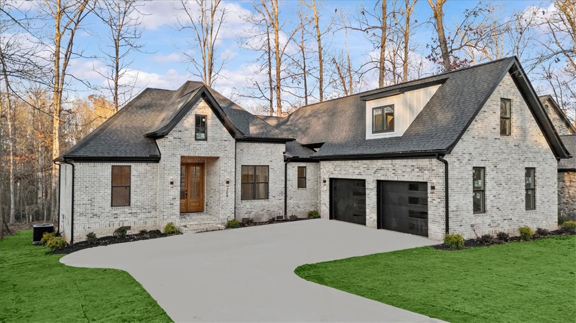 304 Avenue Of Oaks Anderson, SC 29621 - Photo 2 of 38 This charming residence showcases timeless brickwork, a dark roof, and a welcoming front entrance.