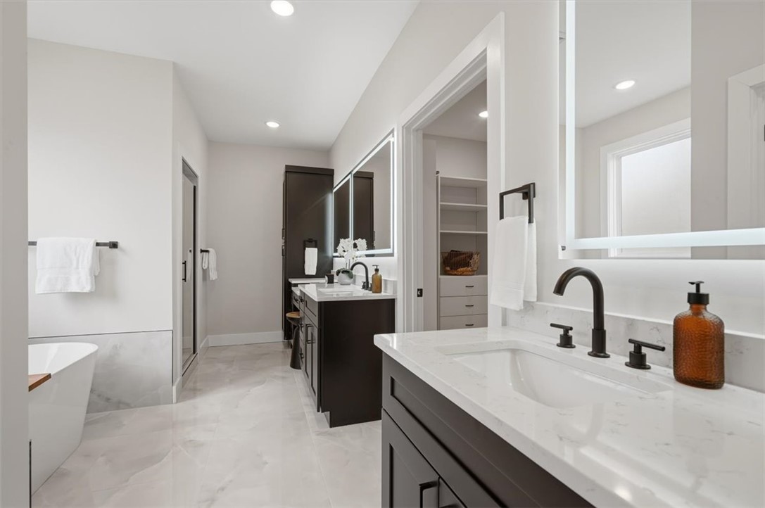 304 Avenue Of Oaks Anderson, SC 29621 - Photo 21 of 38 This spacious bathroom offers elegant fixtures, modern vanities, and a generous walk-in closet.