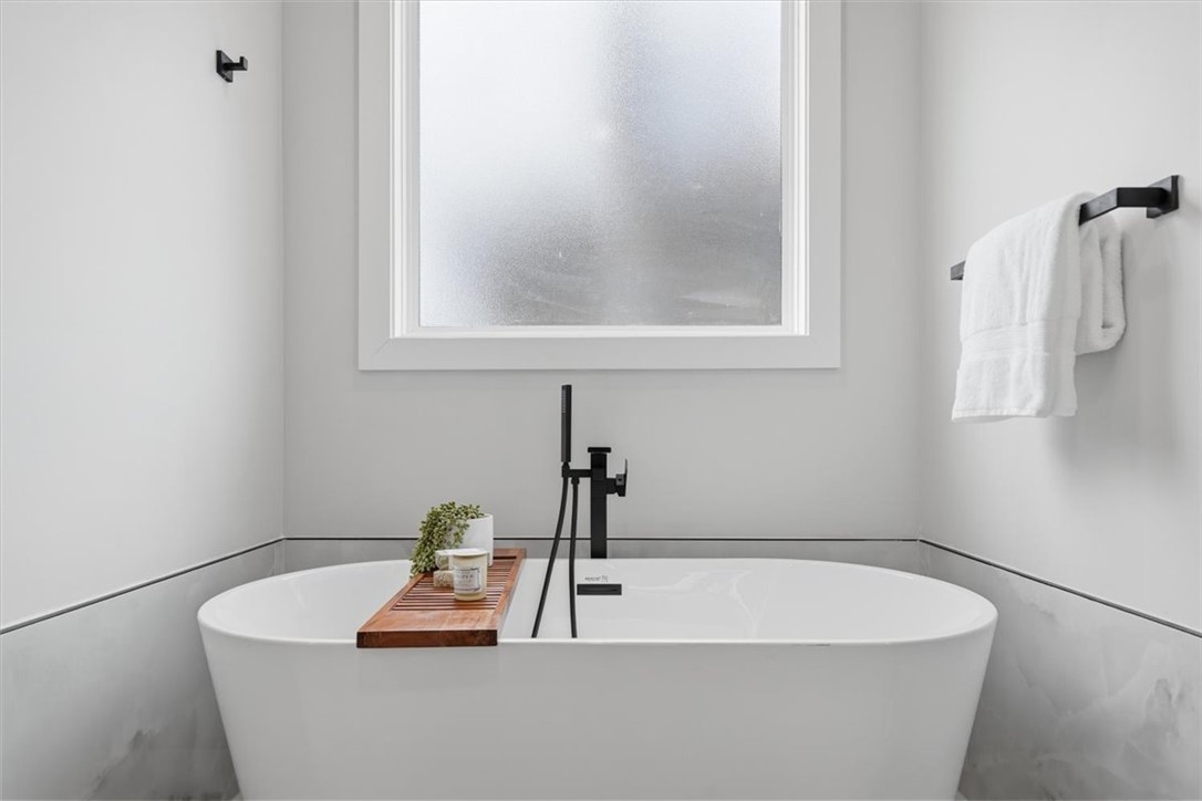 304 Avenue Of Oaks Anderson, SC 29621 - Photo 22 of 38 This serene bathroom offers a spacious soaking tub, perfect for unwinding after a long day.