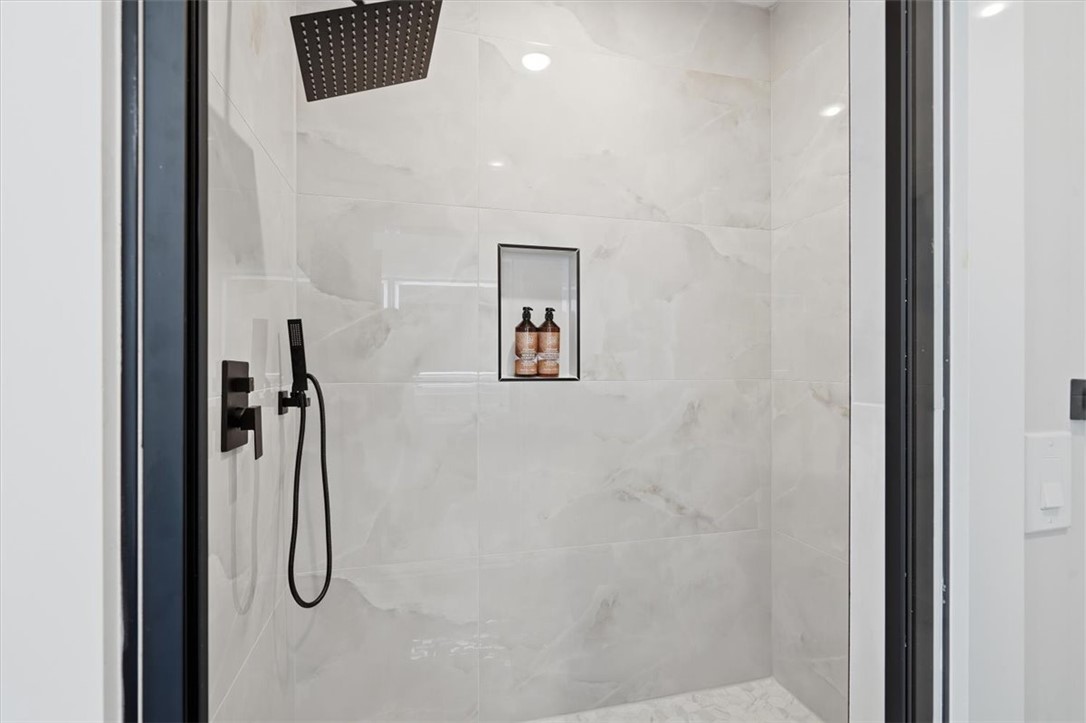 304 Avenue Of Oaks Anderson, SC 29621 - Photo 25 of 38 This sleek shower features modern fixtures and an integrated niche for toiletries.