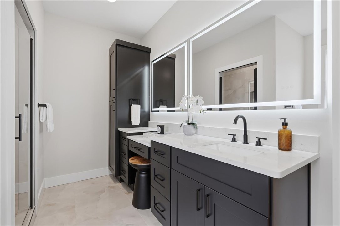 304 Avenue Of Oaks Anderson, SC 29621 - Photo 26 of 38 This modern bathroom features a sleek vanity with ample storage, a bright mirror, and a glass-enclosed shower.