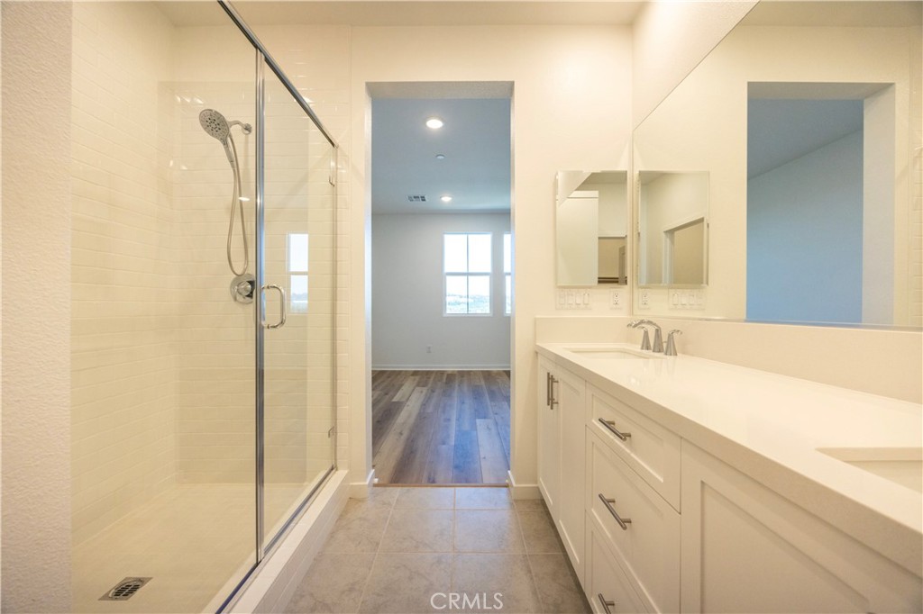 22007 Florence Circle Walnut, CA 91789 - Photo 17 of 30 a spacious bathroom with a double vanity sink a mirror and a shower