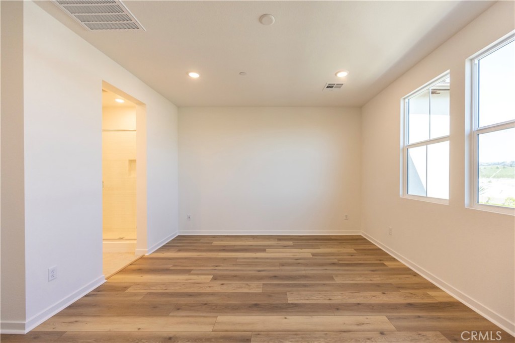 22007 Florence Circle Walnut, CA 91789 - Photo 20 of 30 an empty room with wooden floor and windows