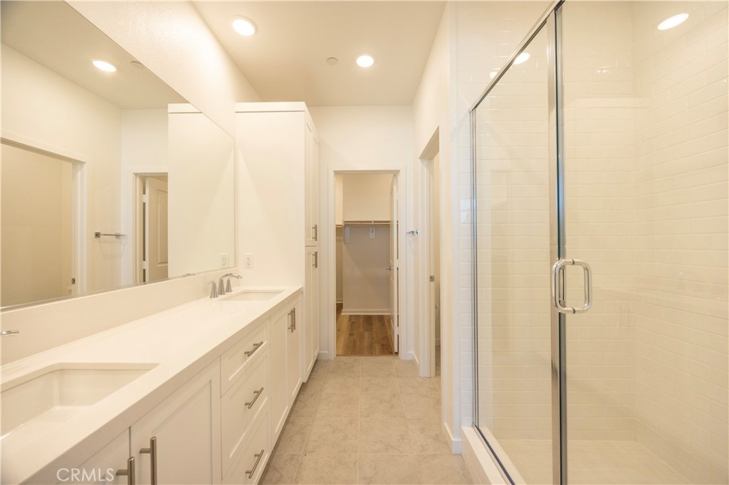 22007 Florence Circle Walnut, CA 91789 - Photo 21 of 30 a bathroom with a double vanity sink mirror and shower