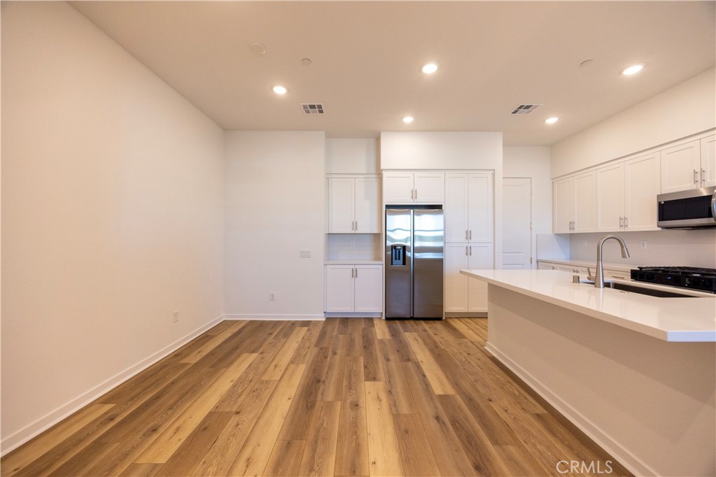 22007 Florence Circle Walnut, CA 91789 - Photo 6 of 30 a kitchen with granite countertop stainless steel appliances refrigerator sink and microwave