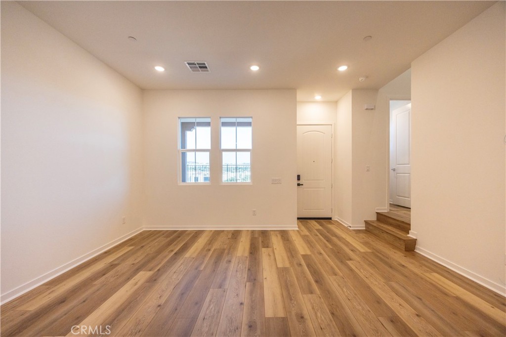 22007 Florence Circle Walnut, CA 91789 - Photo 10 of 30 an empty room with wooden floor and windows