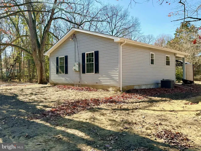 a front view of house with yard covered in snow