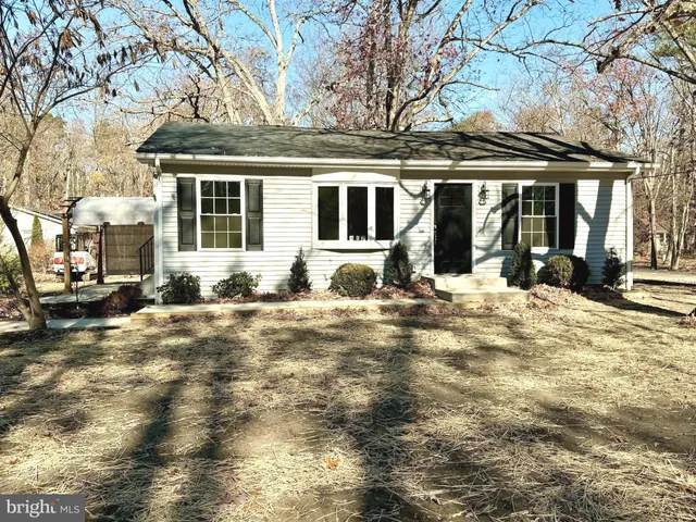 a view of a house with a yard covered in snow