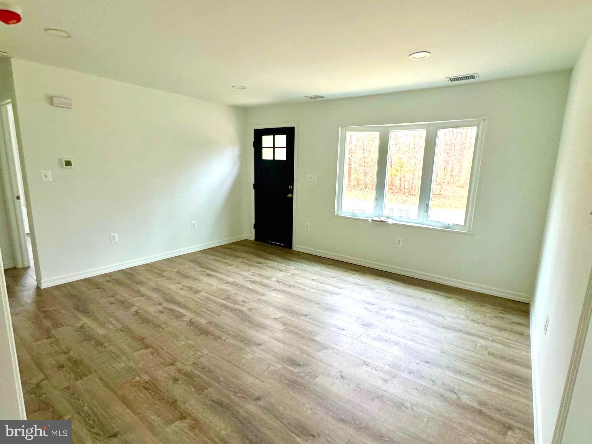 25 Cramer Road Tabernacle, NJ 08088 - Photo 6 of 20 an empty room with wooden floor and windows