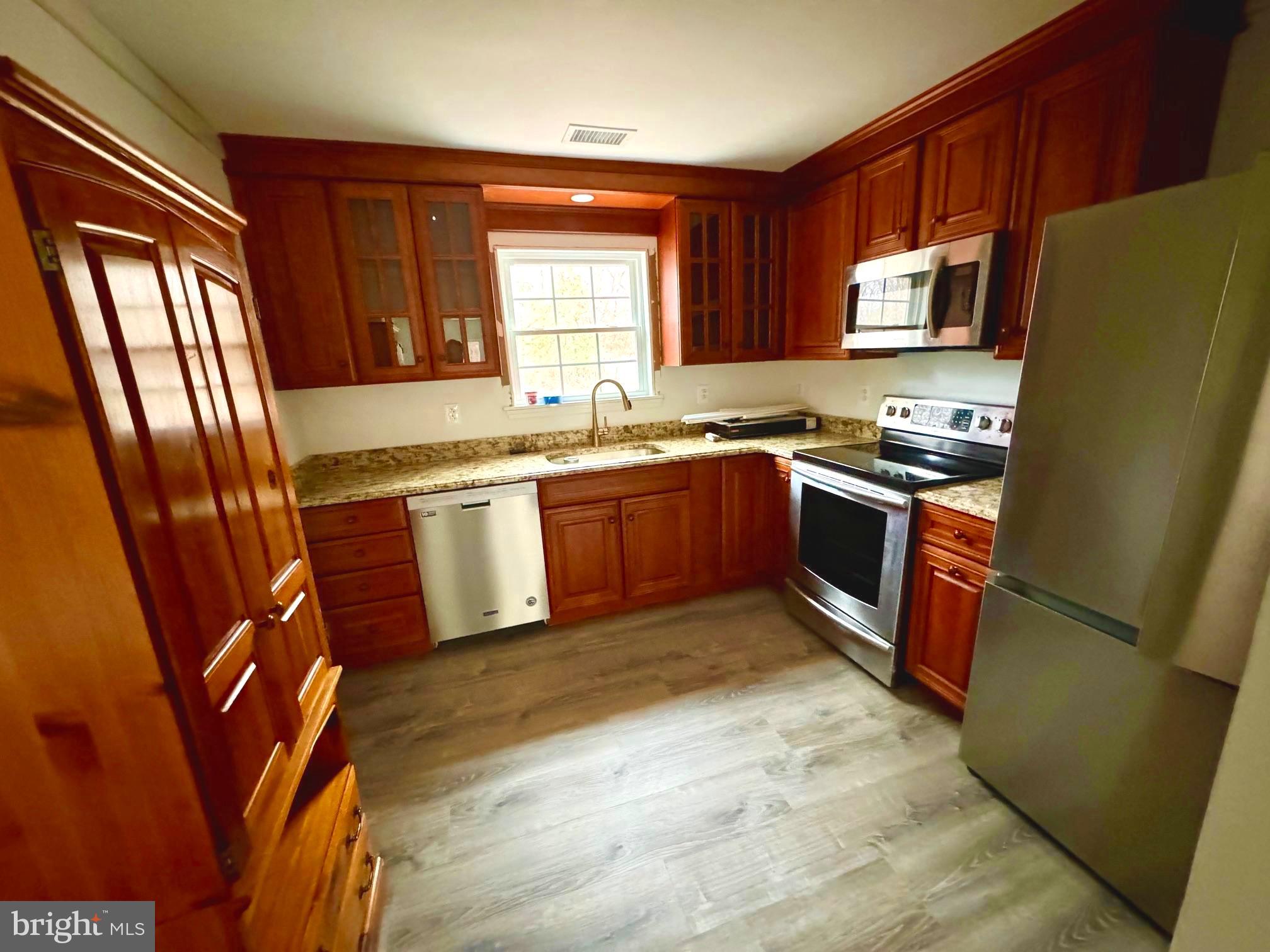 25 Cramer Road Tabernacle, NJ 08088 - Photo 7 of 20 a kitchen with stainless steel appliances granite countertop a stove top oven a sink dishwasher a refrigerator and a microwave