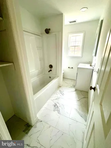 a bathroom with a sink a toilet and bathtub