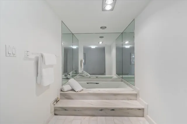 a bathroom with a sink mirror and a shower