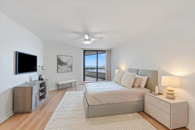 a bedroom with a large bed and a flat screen tv