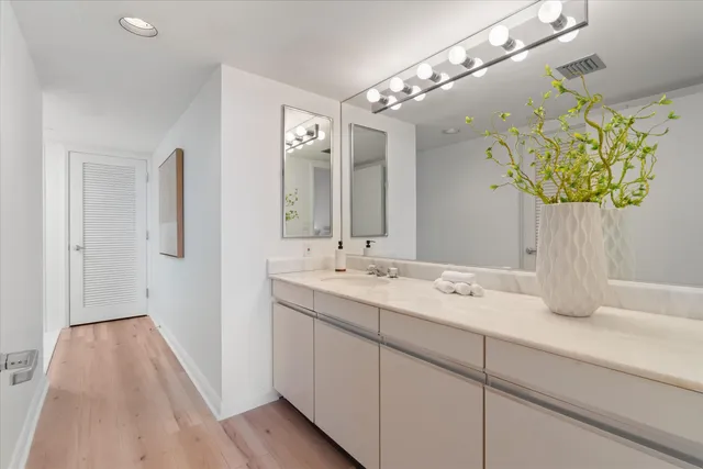 a bathroom with a sink a vanity and a mirror