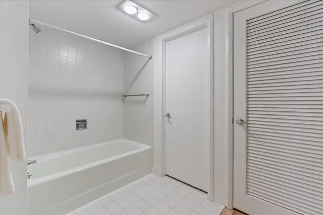 a spacious bathroom with a bathtub and a shower