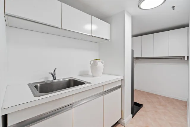 a kitchen with a sink and cabinets