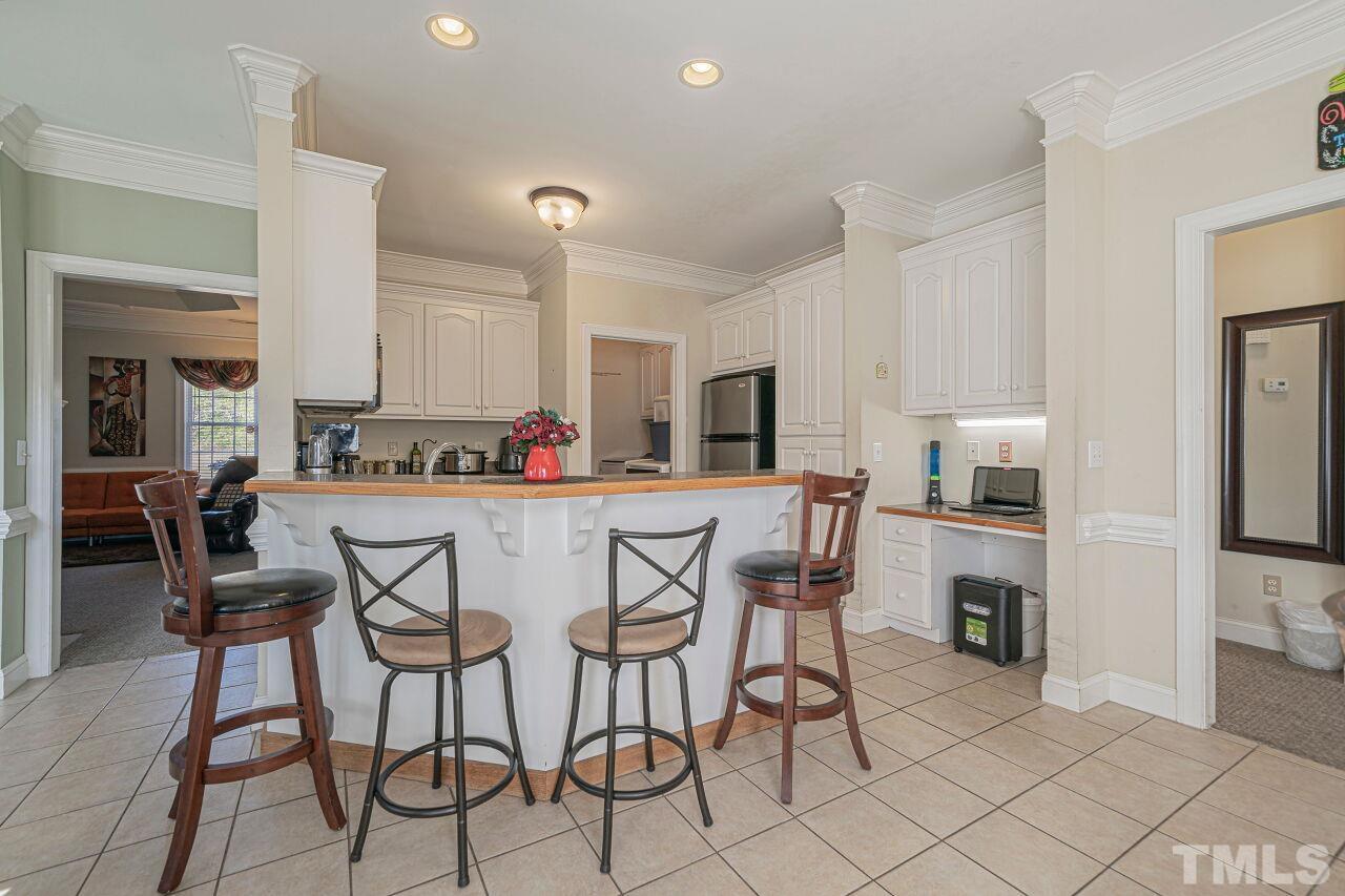 11563 Rockside Road Middlesex, NC 27557 - Photo 16 of 53 a kitchen with stainless steel appliances kitchen island granite countertop a table and chairs in it
