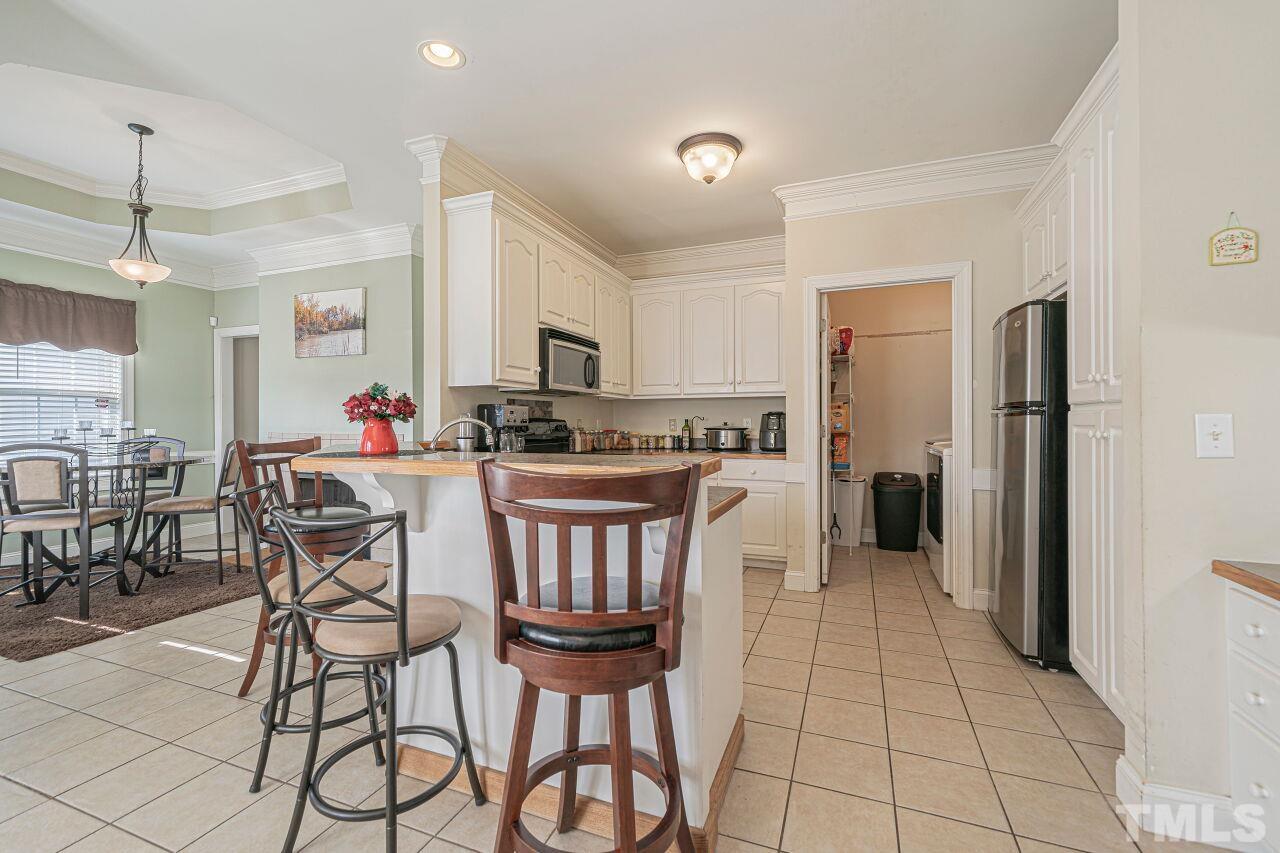 11563 Rockside Road Middlesex, NC 27557 - Photo 17 of 53 a kitchen with stainless steel appliances a refrigerator and a stove top oven