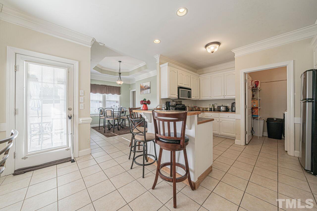 11563 Rockside Road Middlesex, NC 27557 - Photo 18 of 53 a kitchen with stainless steel appliances kitchen island granite countertop a refrigerator and cabinets