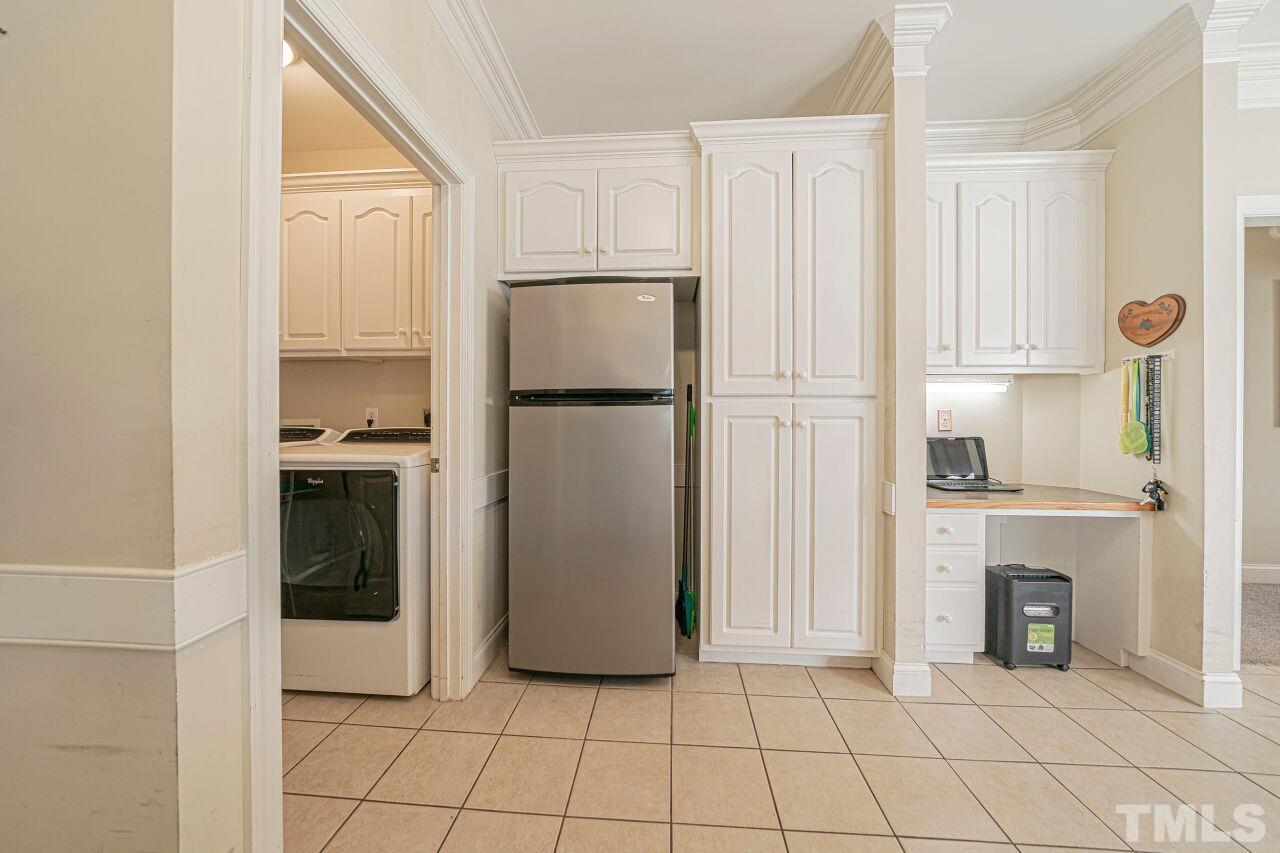 11563 Rockside Road Middlesex, NC 27557 - Photo 21 of 53 a kitchen with cabinets and a refrigerator