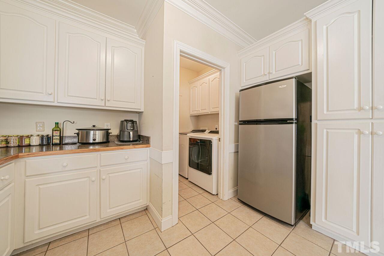 11563 Rockside Road Middlesex, NC 27557 - Photo 22 of 53 a kitchen with white cabinets and white appliances