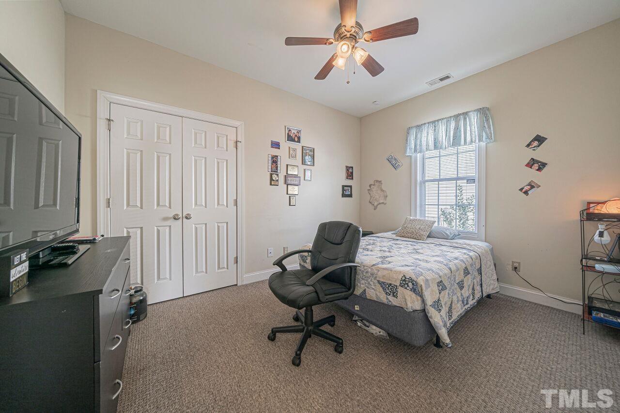 11563 Rockside Road Middlesex, NC 27557 - Photo 26 of 53 a bedroom that has a bed and a chair in it