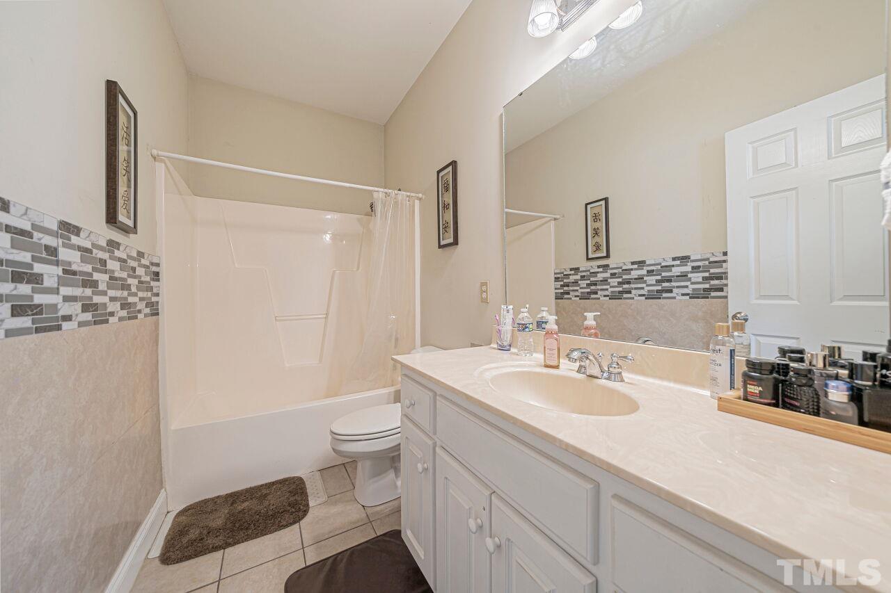 11563 Rockside Road Middlesex, NC 27557 - Photo 27 of 53 a bathroom with a sink a toilet and shower
