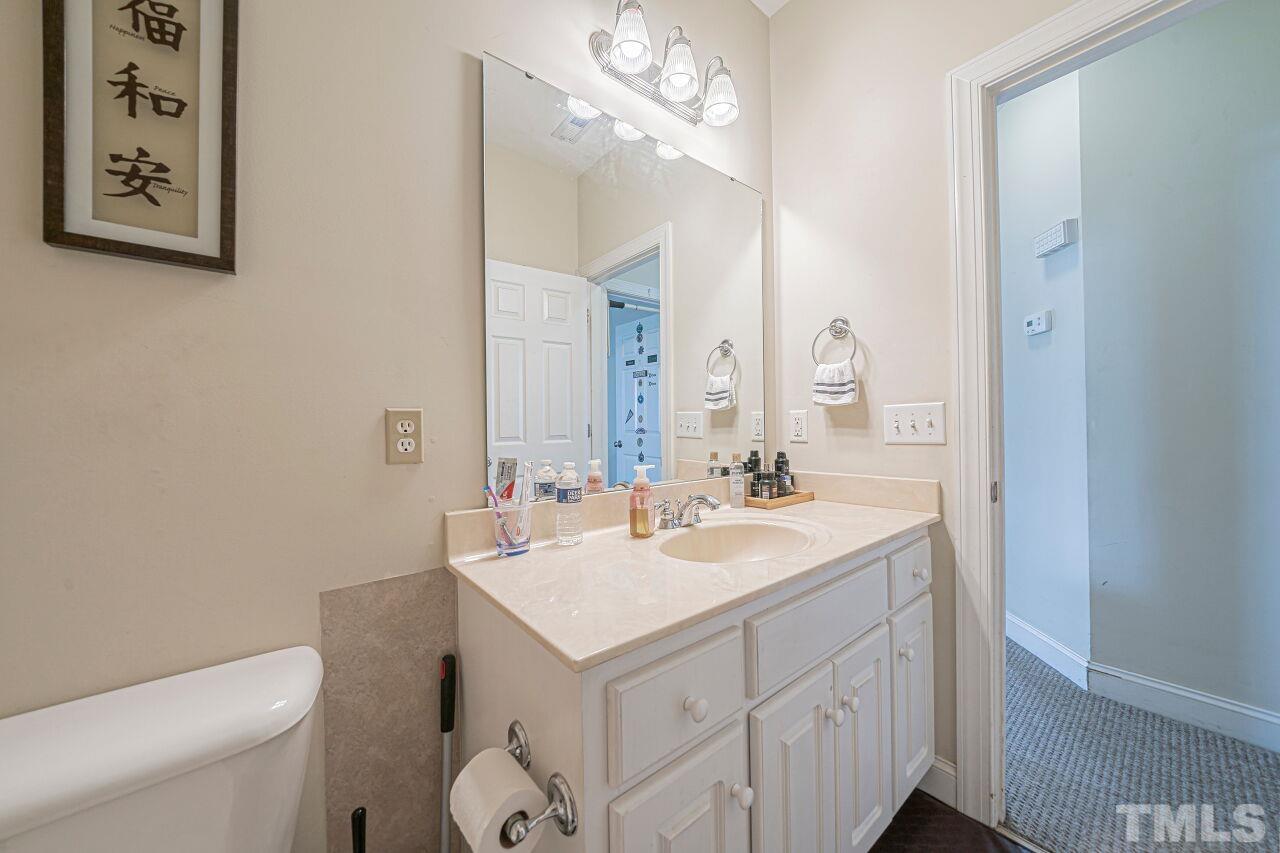 11563 Rockside Road Middlesex, NC 27557 - Photo 28 of 53 a bathroom with a sink a toilet and mirror