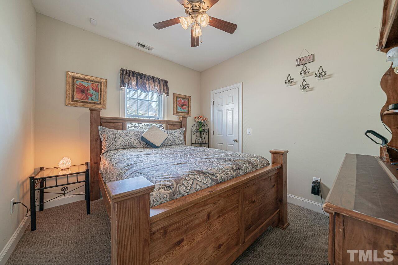 11563 Rockside Road Middlesex, NC 27557 - Photo 29 of 53 a bedroom with a bed and a chandelier