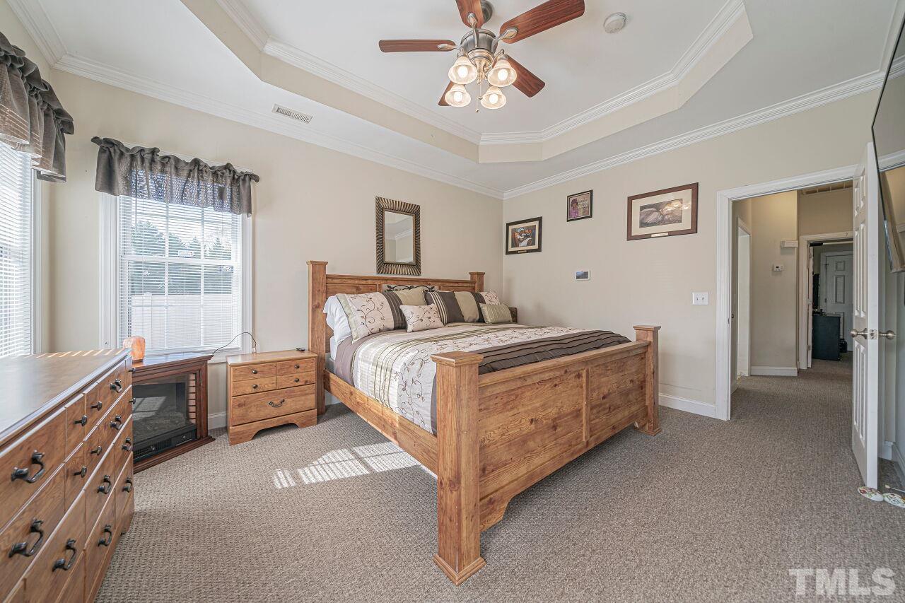 11563 Rockside Road Middlesex, NC 27557 - Photo 31 of 53 a bedroom with a bed and a chandelier
