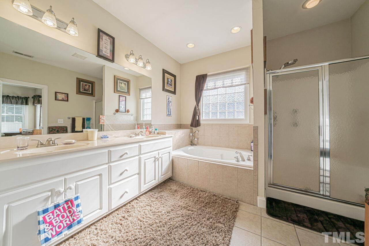 11563 Rockside Road Middlesex, NC 27557 - Photo 34 of 53 a spacious bathroom with a tub sink and a mirror