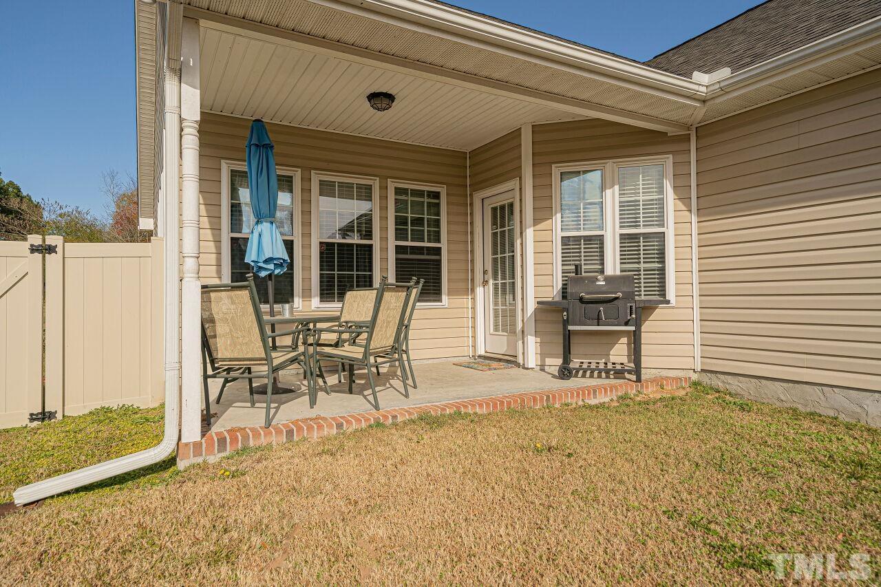 11563 Rockside Road Middlesex, NC 27557 - Photo 50 of 53 a table and chair in front of a house