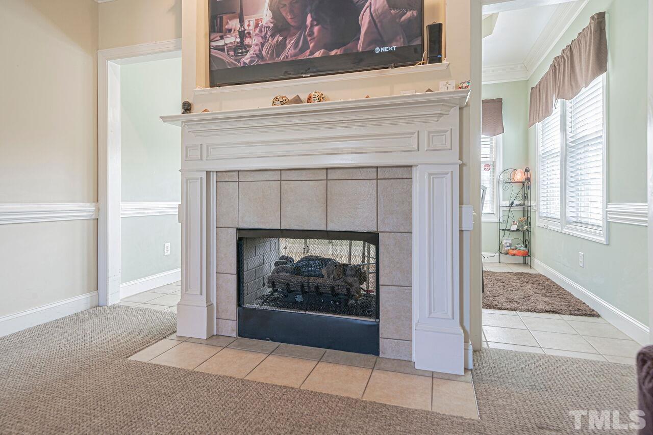11563 Rockside Road Middlesex, NC 27557 - Photo 7 of 53 a living room with a fireplace and a window
