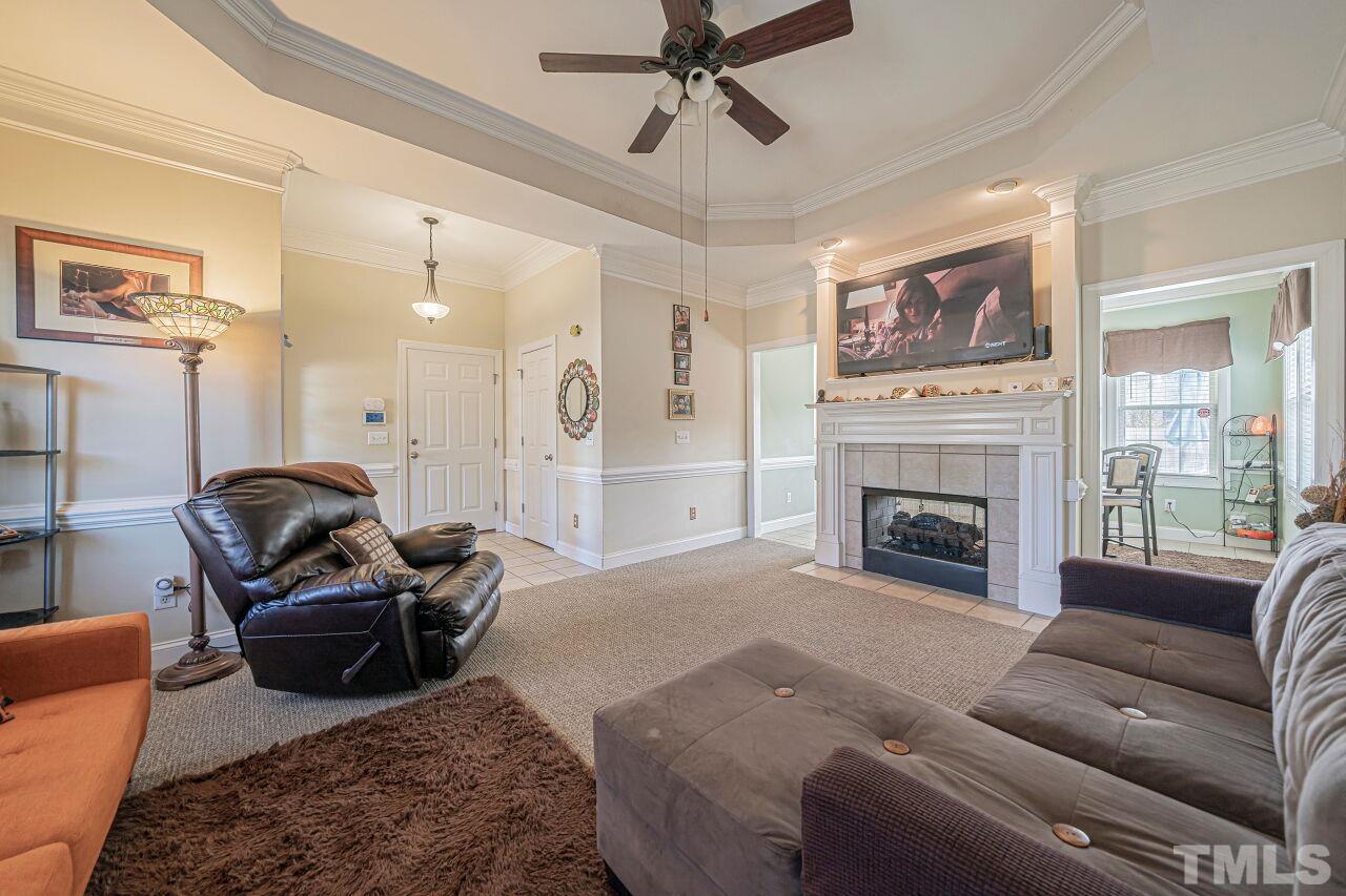 11563 Rockside Road Middlesex, NC 27557 - Photo 8 of 53 a living room with furniture a flat screen tv and a fireplace