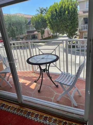 a view of a balcony with furniture