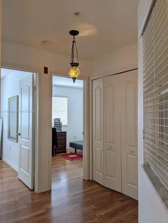 a view of a hallway view with wooden floor and staircase