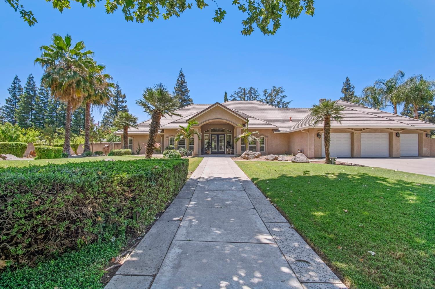 a front view of a house with a garden and yard