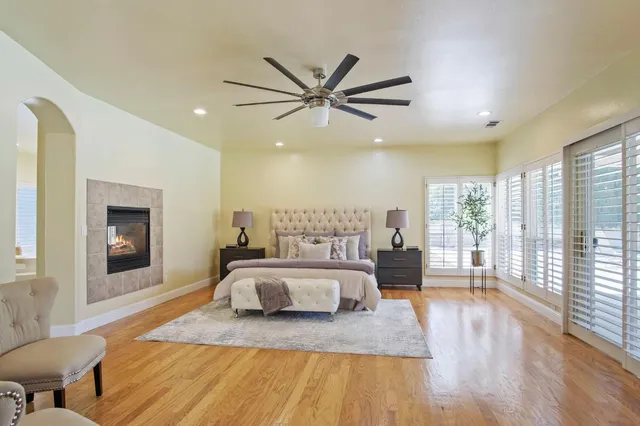 a spacious bedroom with a large bed and a large window