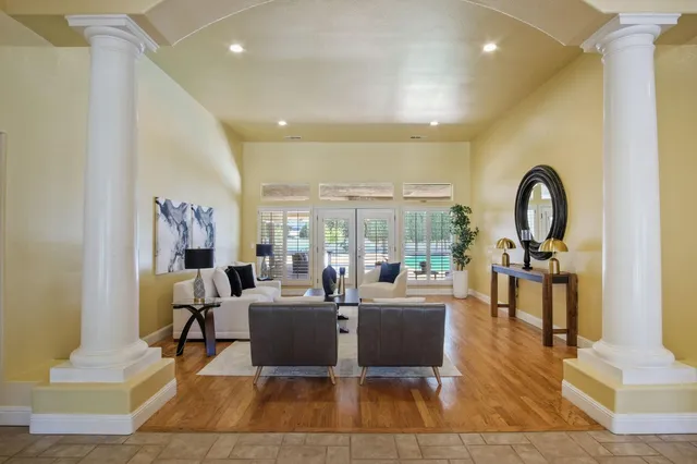 a living room with fireplace furniture and a large window
