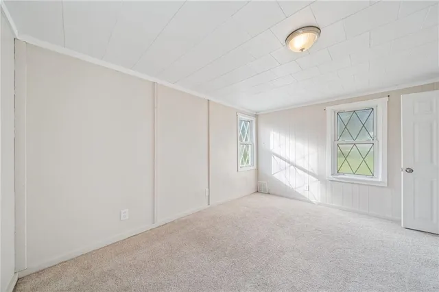 an empty room with windows and closet