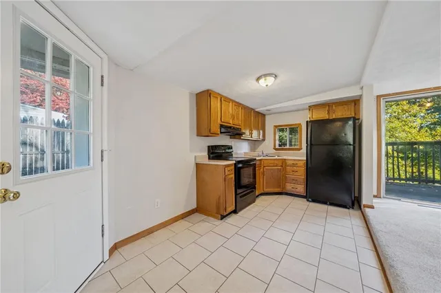 an empty room with a fireplace and a window