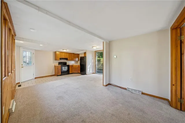 a view of a kitchen with refrigerator stove and a sink