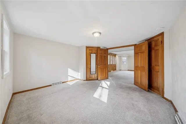 a view of an empty room and a window