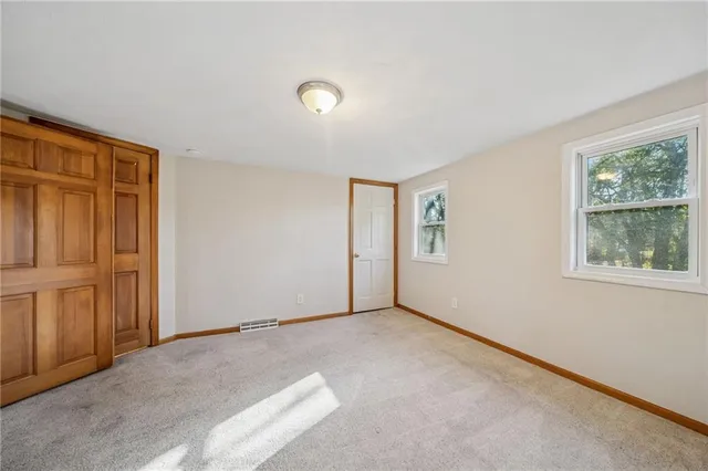 a bathroom with a granite countertop sink a toilet a mirror and bathtub