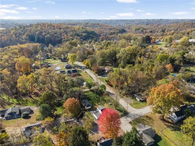 an aerial view of a house with a yard and garden