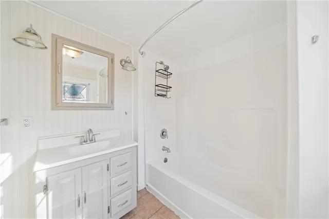 a bathroom with a sink a mirror and a bathtub