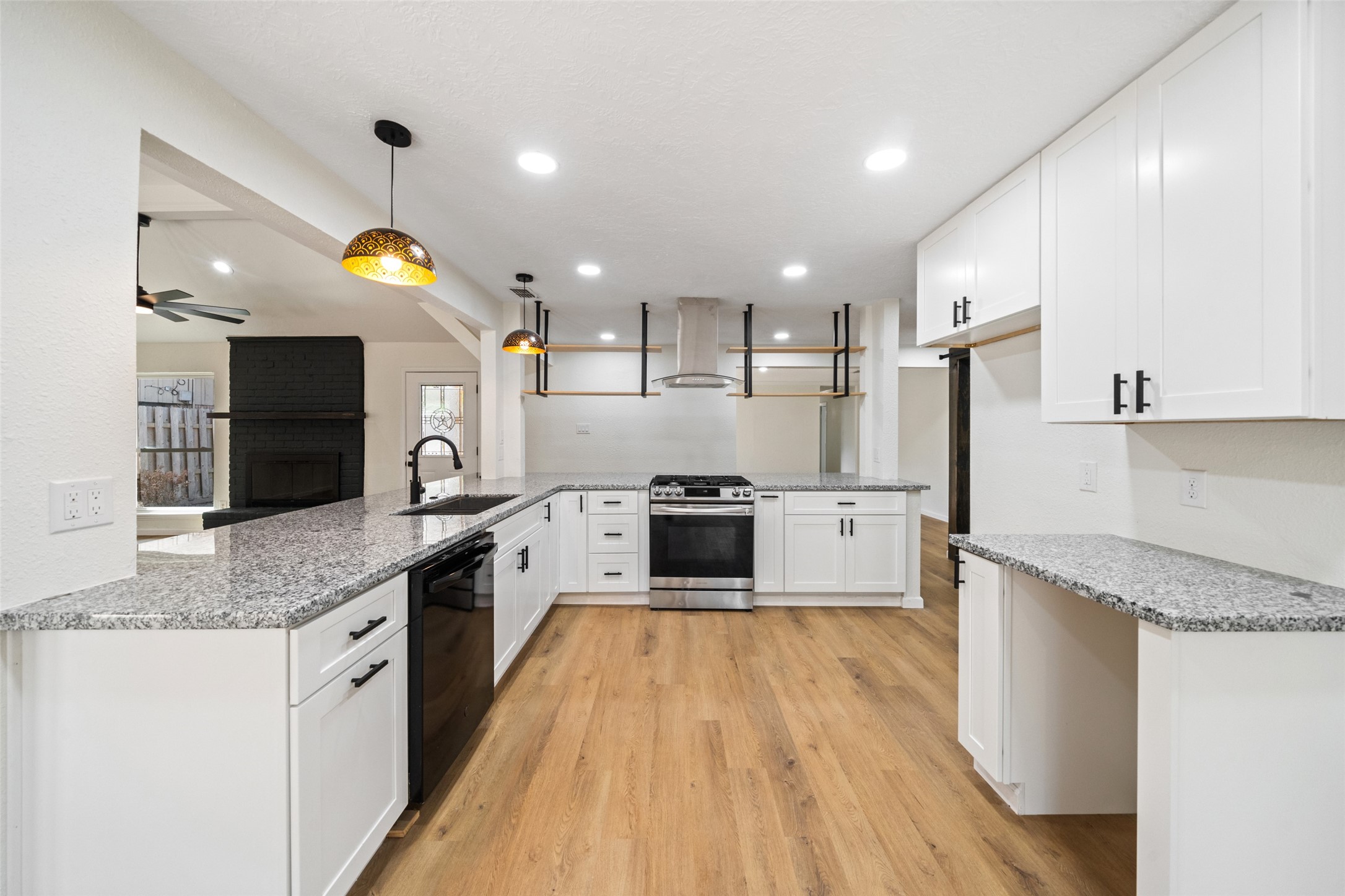 238 Point Clear Drive Conroe, TX 77304 - Photo 6 of 20 a large kitchen with stainless steel appliances granite countertop a lot of counter space and wooden floor