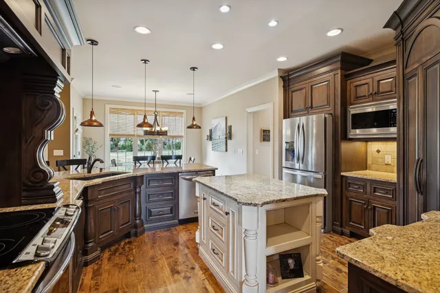 a kitchen with stainless steel appliances granite countertop a stove and a sink