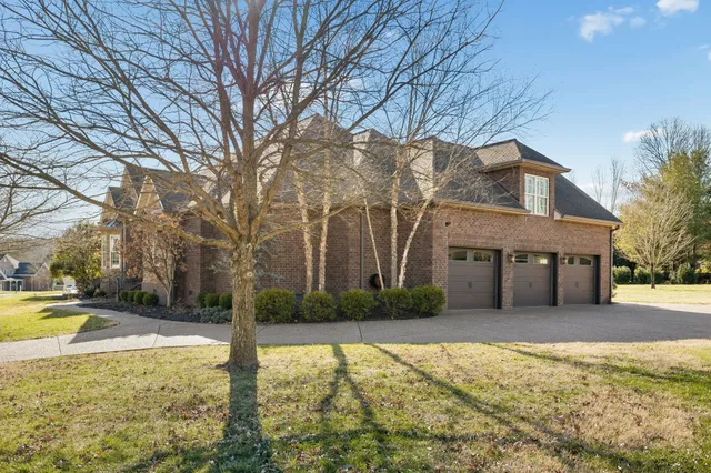 a front view of house with yard and trees around