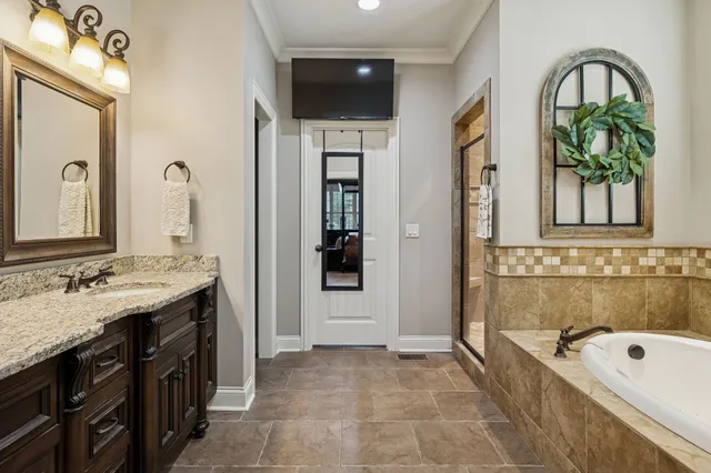 a bathroom with a bathtub sink and mirror
